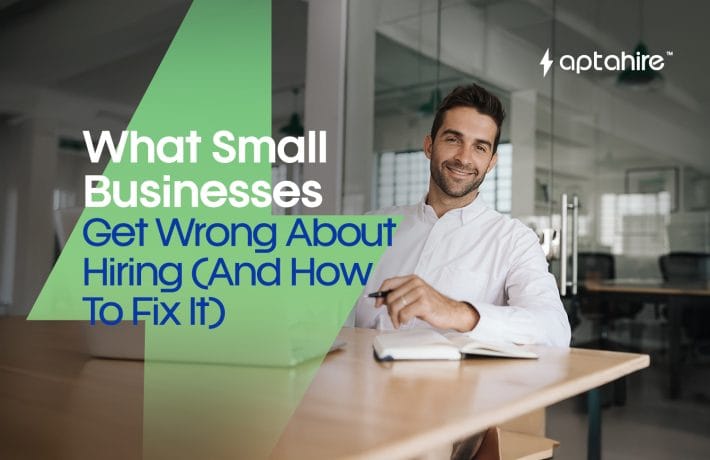 Frustrated small business owner reviewing resumes at their desk, surrounded by paperwork